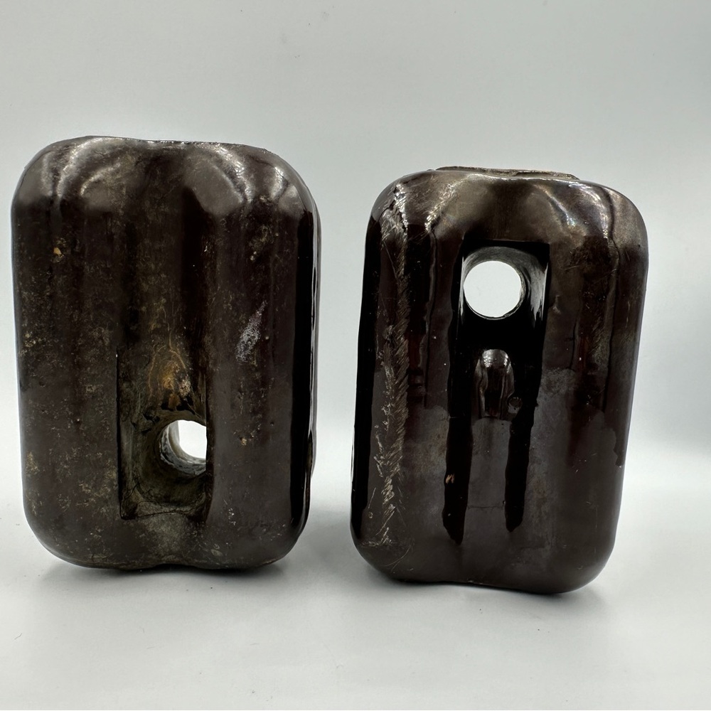 2 brown porcelain insulators